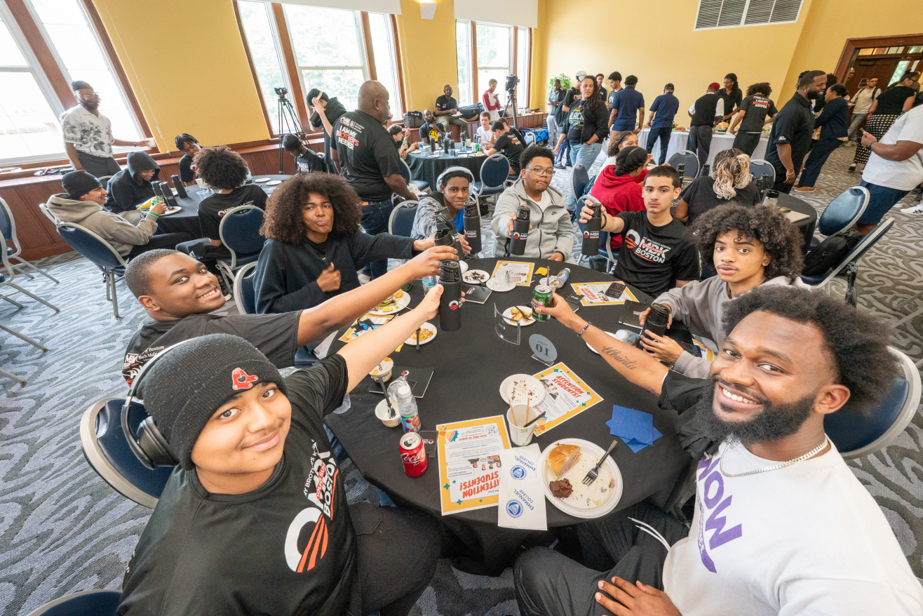 BPS students sit at a table in the auditorium