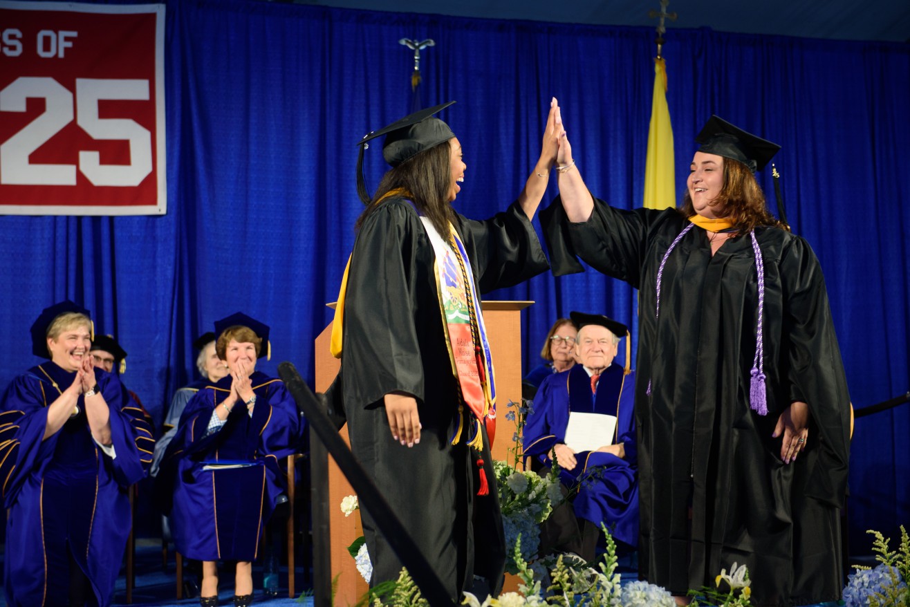 tassel turners high five on stage