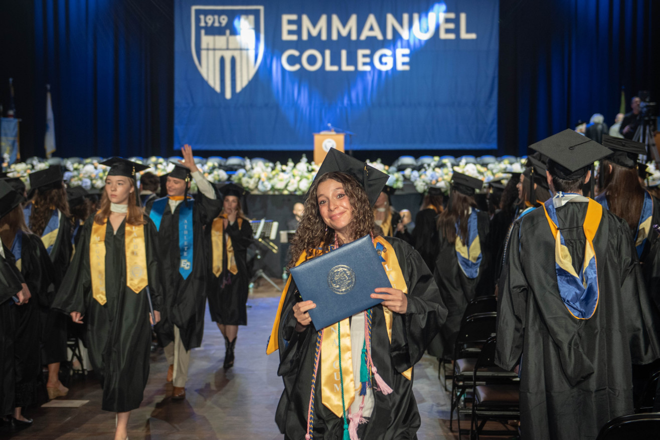 a young woman holds a degree